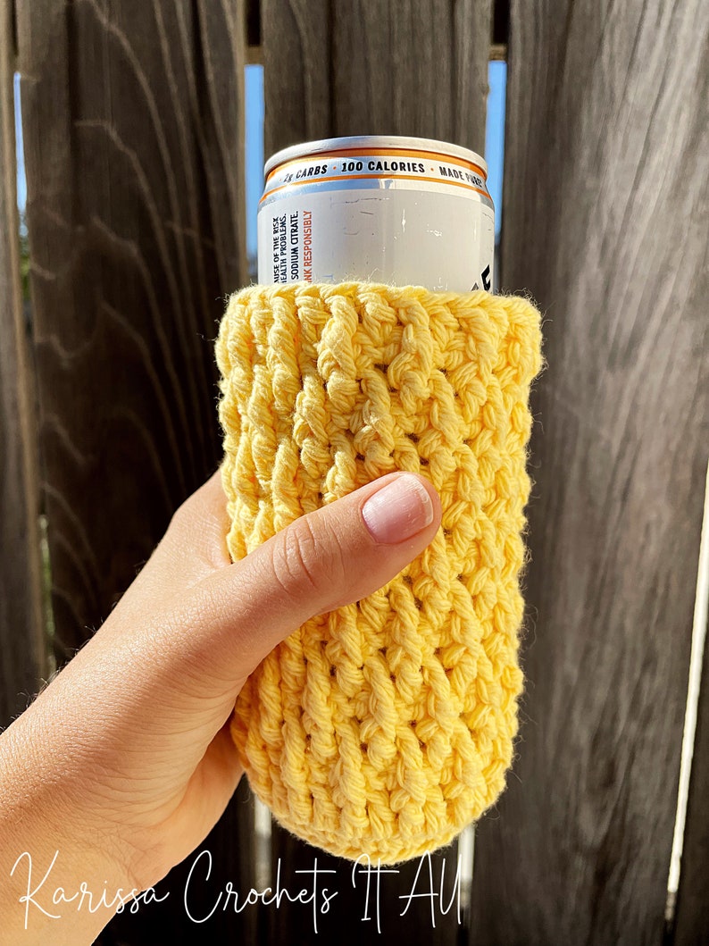 May include: A yellow crocheted can cosy, ideal for keeping your beverage cold. The cosy is made with a simple stitch pattern and is a great way to add a touch of personality to your drink.