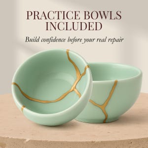 May include: Two light green ceramic bowls with gold-colored kintsugi-style repair lines. The bowls are on a light brown surface. Text at the top reads "PRACTICE BOWLS INCLUDED" and below that, "Build confidence before your real repair."