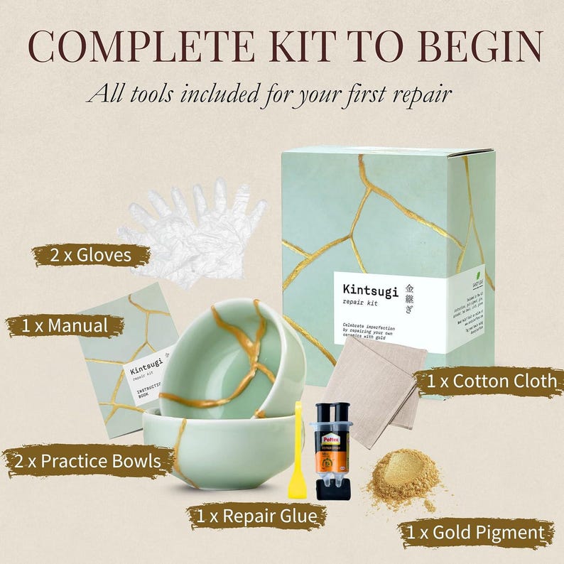May include: Kintsugi repair kit with practice bowls, repair glue, gold pigment, cotton cloth, gloves, and a manual. The kit includes all tools to begin your first repair. The box is light green with gold accents.