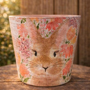 May include: A set of three ceramic mugs with a speckled, matte finish. The mugs are in shades of cream, light gray, and dark gray. Each mug has a simple, minimalist design, perfect for coffee or tea.