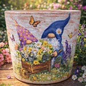 May include: A decorative garden pot featuring a whimsical design of two gnomes pushing a wheelbarrow filled with flowers. The pot is adorned with butterflies and painted with vibrant colors, perfect for adding a touch of charm to any garden or patio.