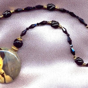 Murano Glass, Modigliani&#39;s Woman in Black Tie, on a blown,  Murano Glass,  Disc  shaped art piece, on a Venetian glass bead necklace.