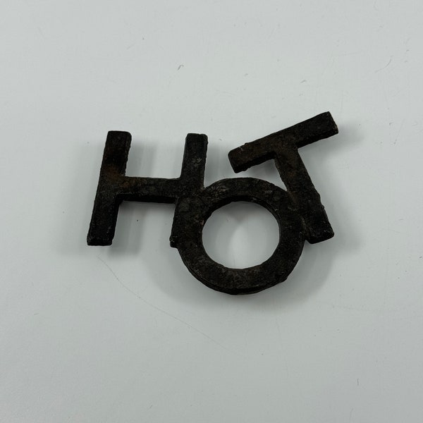 Small metal "HOT" trivet. Made in Taiwan.