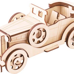 Puede incluir: Modelo de madera de un coche descapotable vintage. El coche está hecho de madera clara con detalles en marrón oscuro. Cuenta con ruedas detalladas, un capó y una capota descapotable. El modelo es un proyecto de bricolaje.