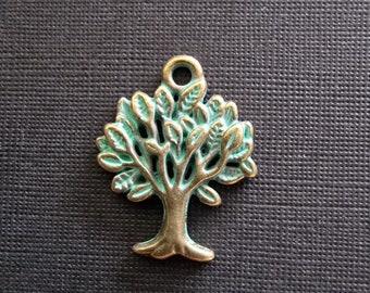 May include: A green and gold metal tree charm pendant. The tree has a detailed design with many branches and leaves.