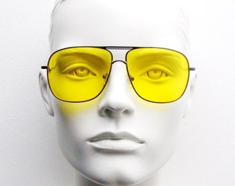 Yellow square aviator sunglasses. Gunmetal grey double bridge metal frame with yellow shooter lenses. Mens 70s design aviators.