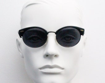 90s vintage modified cat eye sunglasses. Matt black half frame browline cateye. Rockabilly oval cateyes. 50's. Unused NOS