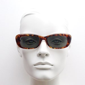 90s vintage soft angled cat eye sunglasses. Vibrant tortoise womens 60s style cateye frame with green lenses. Unused NOS