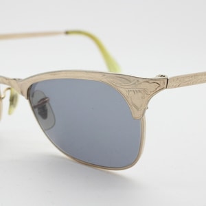 50s vintage 12K gold filled cat eye sunglasses. Radiant slimline cateye frame with ornate patterned tool work. 40s
