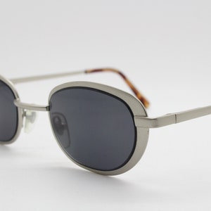 90s vintage oval sunglasses. Small slim flat minimal silver metal frame in brushed satin finish. Unused NOS
