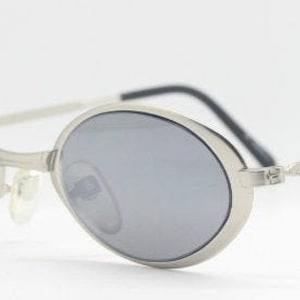 90s vintage oval sunglasses. Small slim flat oval minimal silver metal frame with mirror lenses. Unused NOS