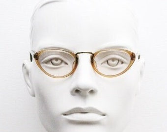 30s vintage eye glasses. Womens triangular early cat eye design. Transparent optical frame with ornate metal bridge. Prescription spectacles