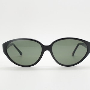 80s vintage cat eye sunglasses. Slender black gloss acetate cateye 50s design frame with green lenses. NOS rockabilly cateyes