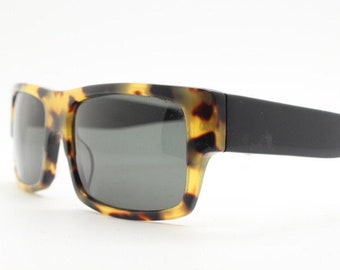 90s vintage thick framed rectangular low profile sunglasses. Handsome transparent mottled beeswax coloured acetate with tall black arms