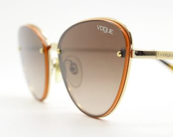 Vogue vintage ovale cat-eye zonnebril. Dames chic gouden frame cateye met verleidelijke, rokerige, aflopende lenzen