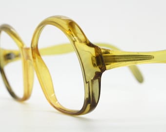 Große runde Vintage Brille aus den 70er Jahren aus Optyl by Cobra. Transparente große gelbe Damenbrillenfassung mit eingekerbten Seiten. Rezept RX