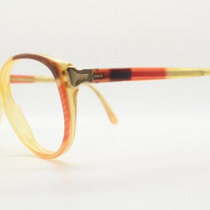 70s vintage round cat eye glasses made in italy by Sferoflex. Womens yellow acetate optical frame with red and brown outline. Prescription