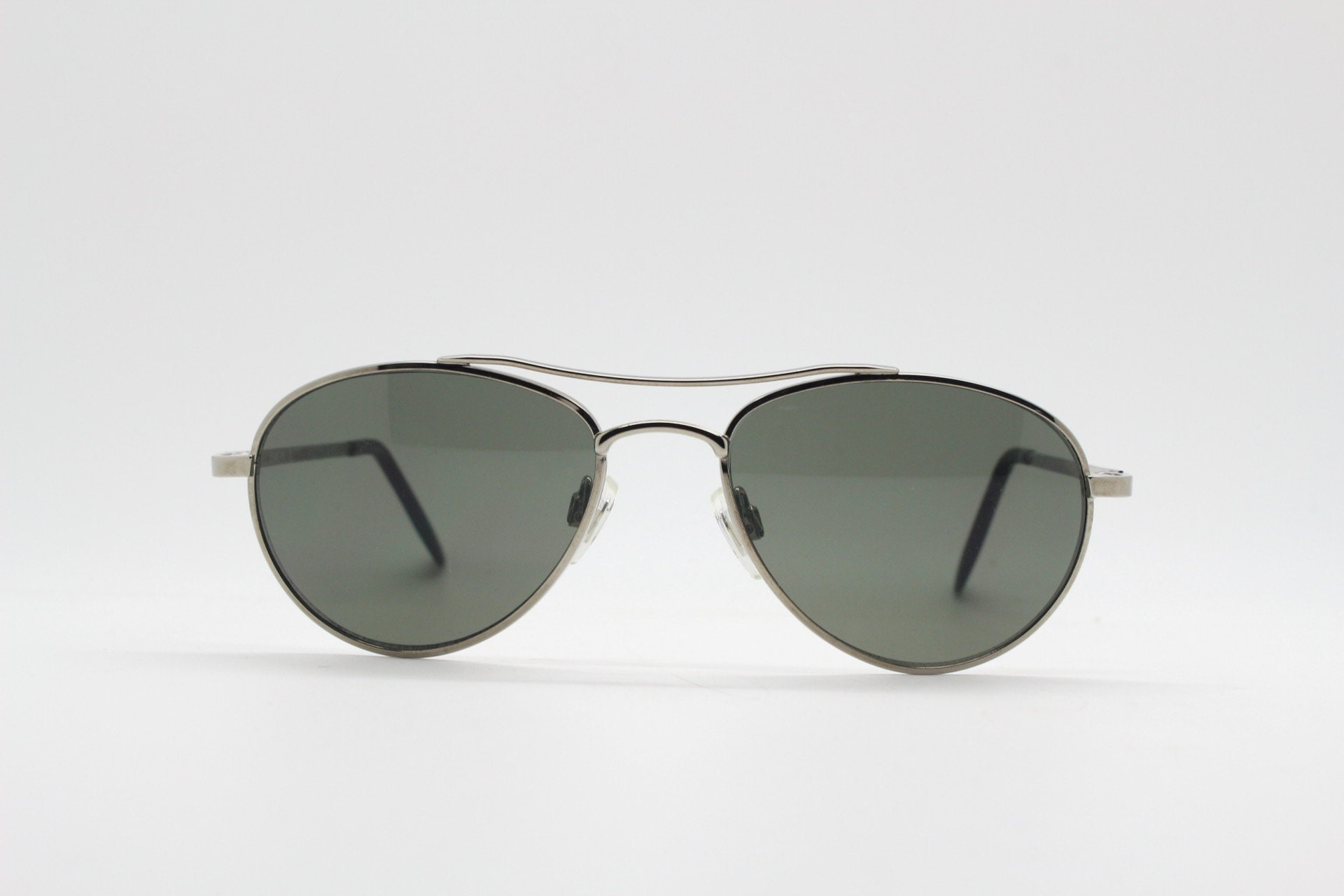 90s vintage mini bug eye aviator sunglasses. Crisp silver chrome teardrop frame with green lenses. Mens small aviators. Pilot NOS