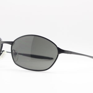 May include: Black oval-shaped sunglasses with a thin metal frame.