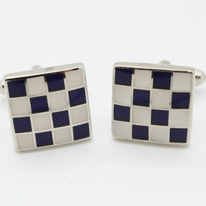 Vintage square checker board cuff links made in England. Solid metal construction with black and white enamel curved surface. NOS