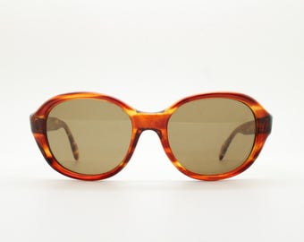 60s medium sized round vintage sunglasses. Mottled honey brown acetate frame with luxury brown glass lenses. Mod. Thomas Crown. NOS
