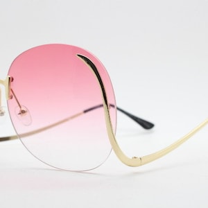 Y2K vintage big round oversized sunglasses. Women&#39;s upside down 70s design with dramatic upswept arms and sultry graduating lenses. NOS