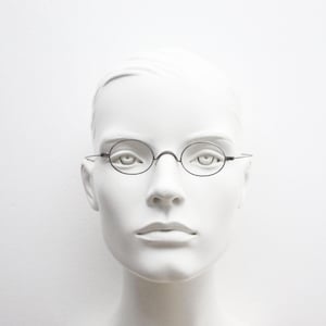 Victorian vintage metal oval eye glasses. Metal wire optical frame with straight arms and saddle bridge. Civil War antique 1800s spectacles