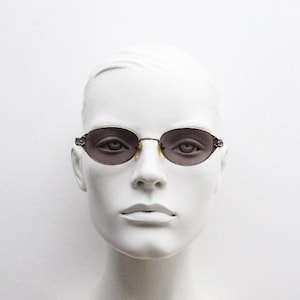 Jean Paul Gaultier 90s vintage oval sunglasses model 58-5103 made in Japan. Tech fashion collectors grail series with ornate arms