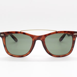 90s vintage wayfarer design sunglasses. All time classic design in a deep honey tiger colour with green lenses and over bar. NOS. 5024
