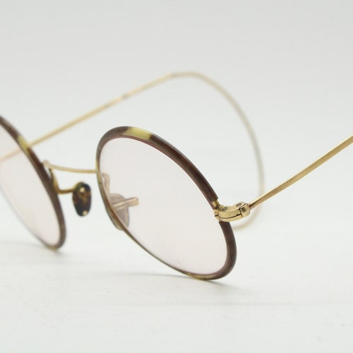 20s, shops 30s vintage glasses. Tortoise lens surrounds on a gold Windsor optical frame with coiled arms. Prescription eyeglasses. RX spectacles