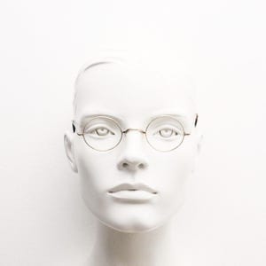 1920s vintage antique round eye glasses. Minimal authentic gold metal optical frame with tortoise ends. Prescription wire RX spectacles