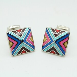 Vintage square cuff links made in England by Herringbone. Solid metal construction with green, blue and pink arrow pattern. NOS