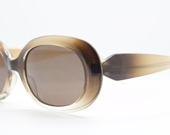 90s vintage oval brown sunglasses. Dense lustrous 60&#39;s mod style frame with gold highlights. Unused NOS