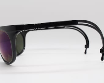 90s vintage wrap around bug eye sunglasses. Imposing black gloss spider arm frame with mirrored lenses. Y2K club kids. Rave 2000s. NOS