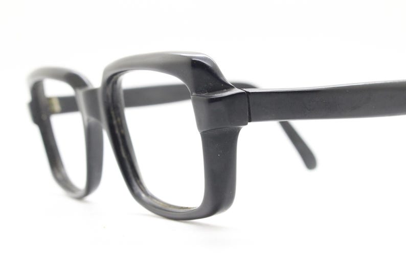 May include: Black plastic framed glasses with a square lens shape.