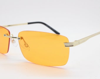 Y2K frameless rectangular sunglasses.  Blazing orange lenses with gunmetal trim and arms. Rave 2000s NOS