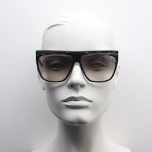 Oroton 80s Vintage sunglasses model 0868 made in Italy. Black frame with marbled acetate brow and smoky lenses. NOS