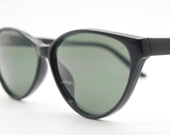 80s vintage cat eye sunglasses. Sharp angled slender black cateye 50s style frame with green lenses. NOS rockabilly cateyes