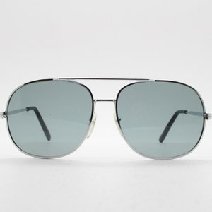 May include: Silver aviator sunglasses with gray lenses.