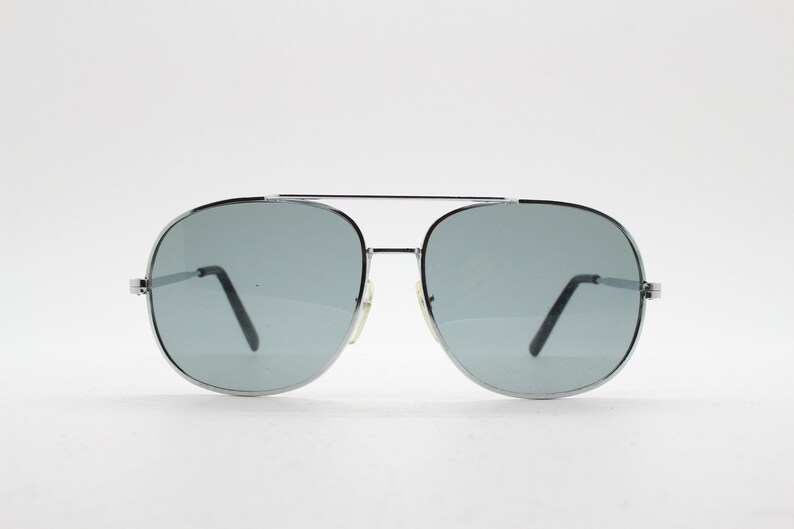 May include: Silver aviator sunglasses with gray lenses.