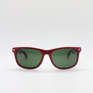 May include: Red plastic sunglasses with green lenses.