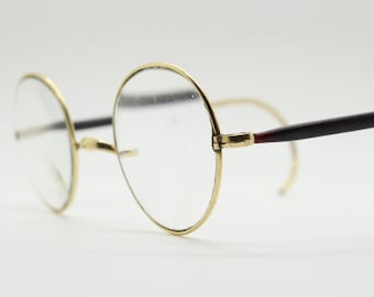 Gafas redondas antiguas de los años 20 bañadas en oro de 10 quilates con patillas de acetato negro y extremos en espiral. Gafas graduadas. Gafas de los años 30.