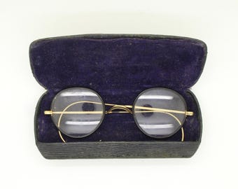 Gafas redondas vintage Algha de los años 30. Montura óptica dorada con cristales negros brillantes y patillas en espiral. Gafas graduadas. Estilo años 20.