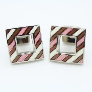Vintage striped square cuff links made in England. Solid metal with cut out centre in pink and red enamel with a matching back. NOS