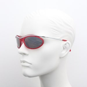 Y2K vintage red sunglasses. Suspended wraparound transparent red frame on chrome brow bar. BNWT. 2000s NOS