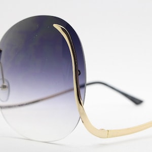 Y2K vintage big round oversized sunglasses. Women&#39;s upside down 70s design with dramatic upswept arms and sultry graduating lenses. NOS