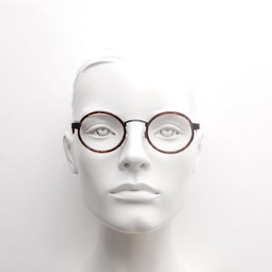 90s vintage oval glasses made in Italy. Black metal frame encasing tortoise insert optical frames. Prescription eyeglasses. RX Spectacles