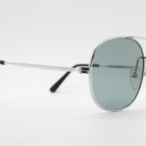 May include: Silver aviator sunglasses with gray lenses and black temple tips.