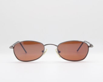 90's vintage oval sunglasses. Small chrome metal frame with brown lenses and black arms. BNWT. Unused NOS