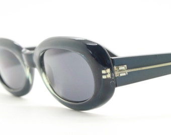 90s vintage oval sunglasses. Curved low profile pearlised chunky blue grey frame with black lenses. Unused NOS. Y2K, 2000s